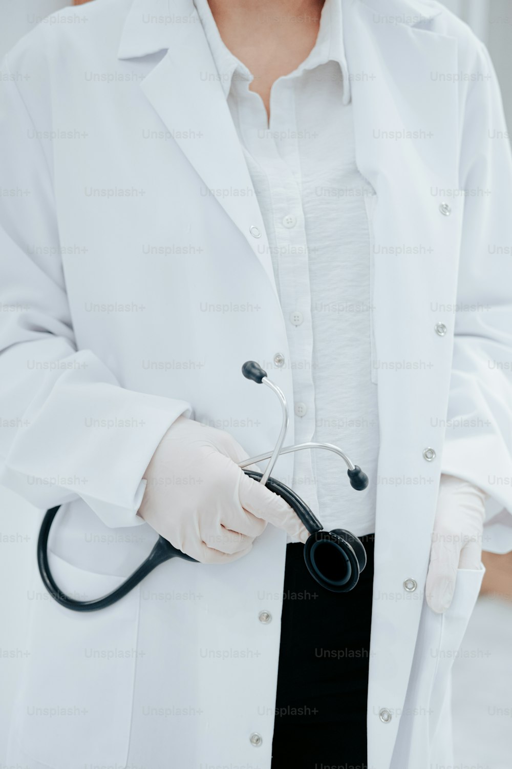 a woman in a white lab coat holding a stethoscope