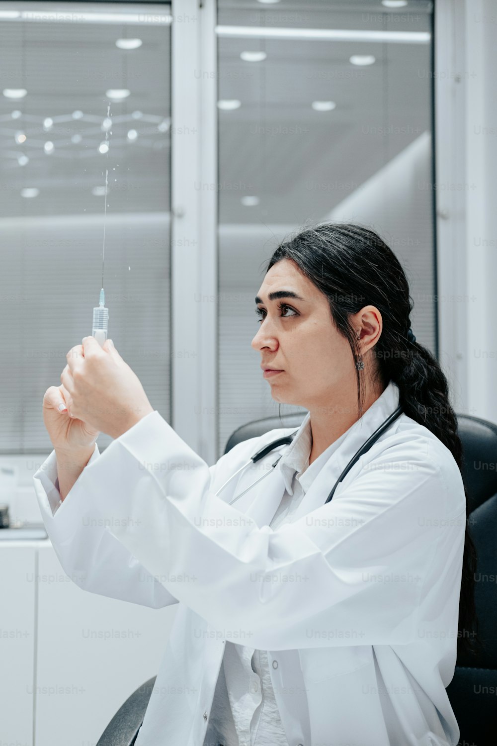 a woman in a white lab coat is holding a syquet