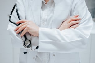 a woman in a white lab coat holding a stethoscope