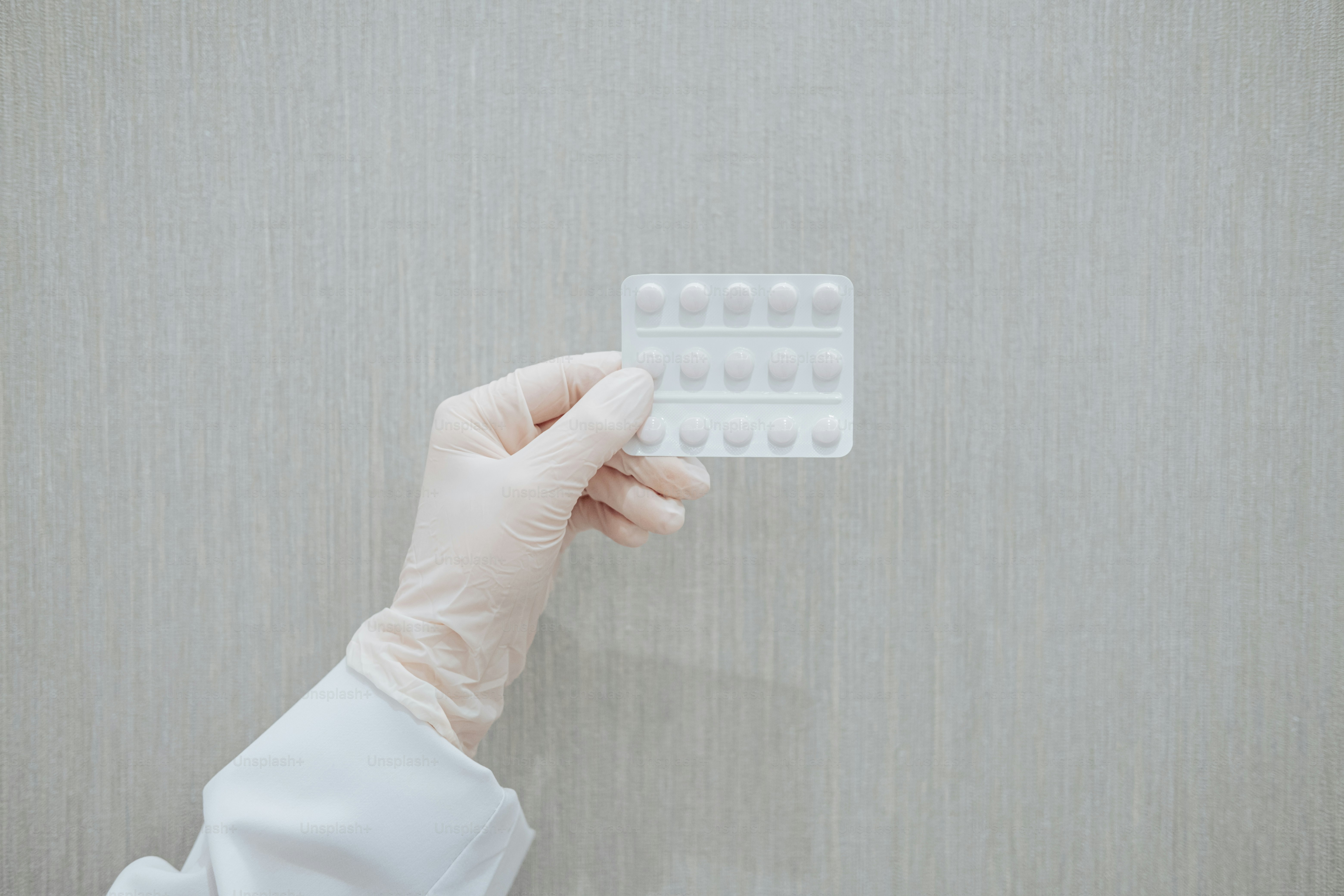 a person in a white coat holding a contraption