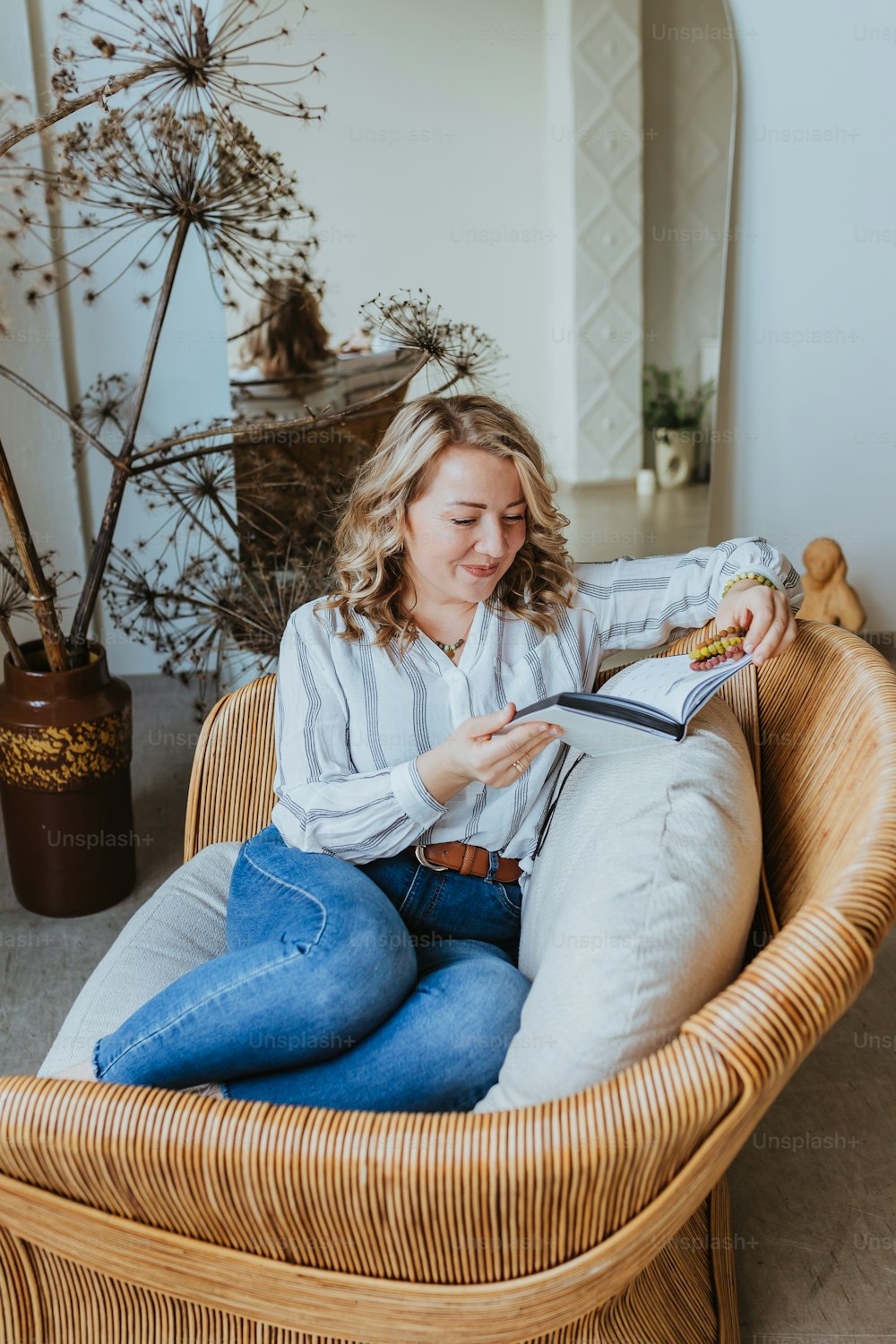 a woman sitting in a chair reading a book