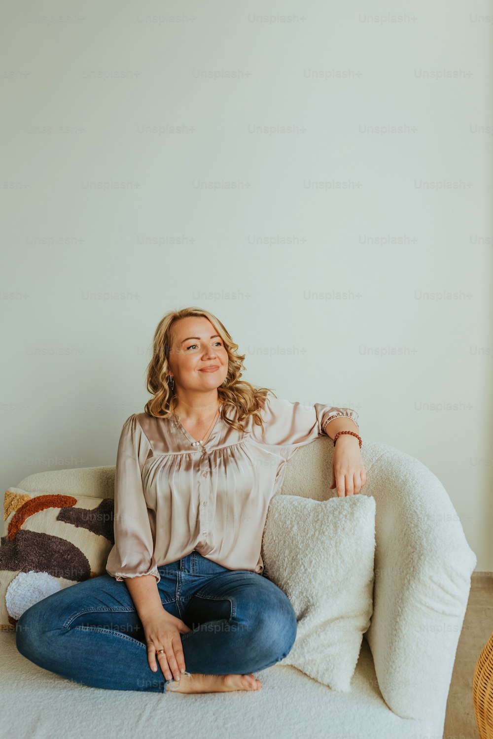 a woman sitting on top of a white couch