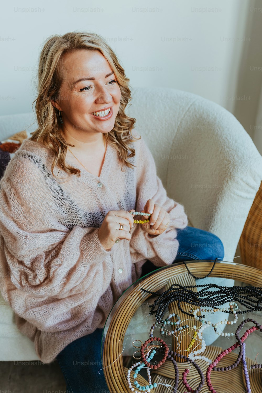 a woman sitting on a couch with a bunch of beads