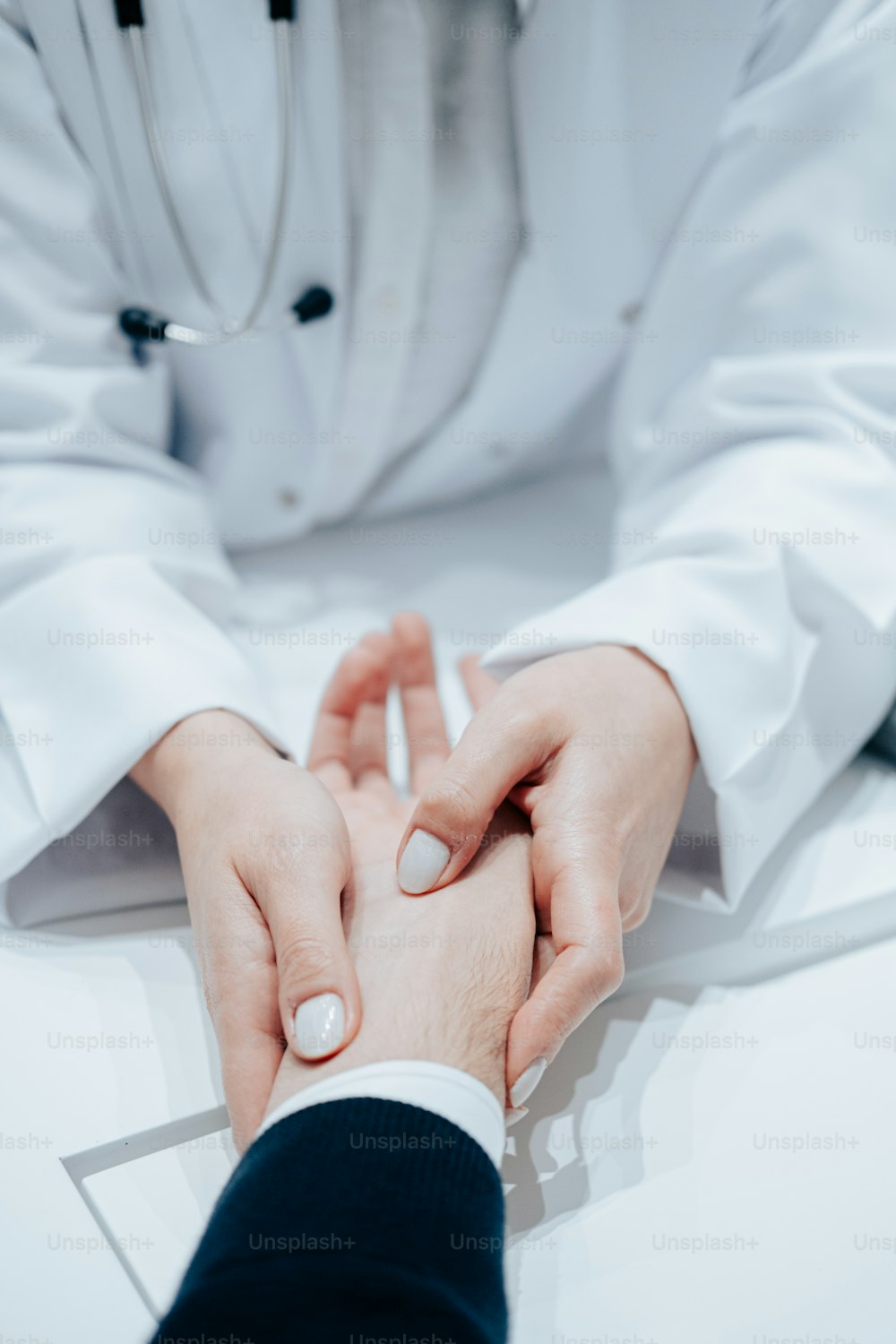 a doctor holding the hand of a patient