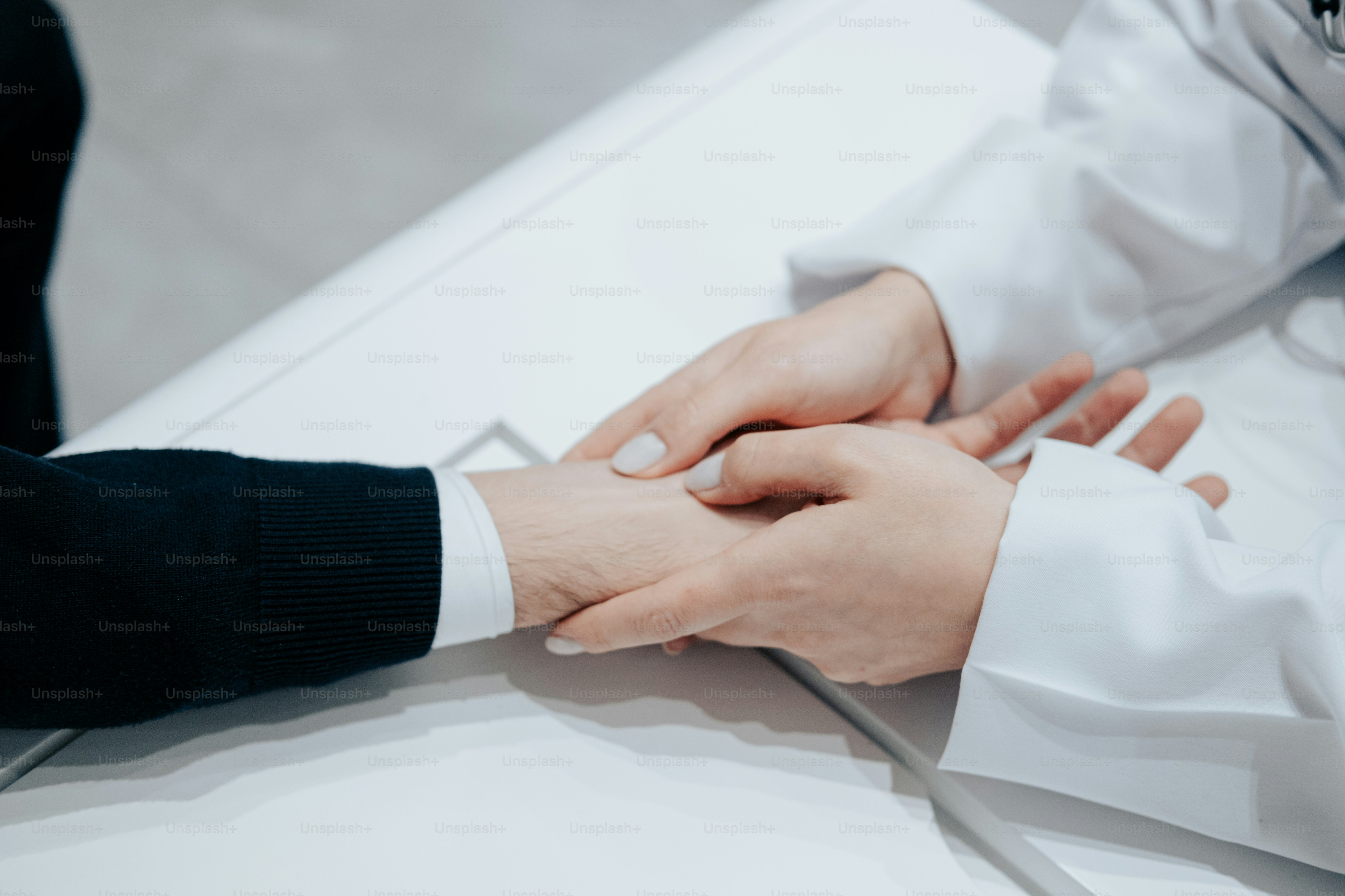 a close up of two people holding hands
