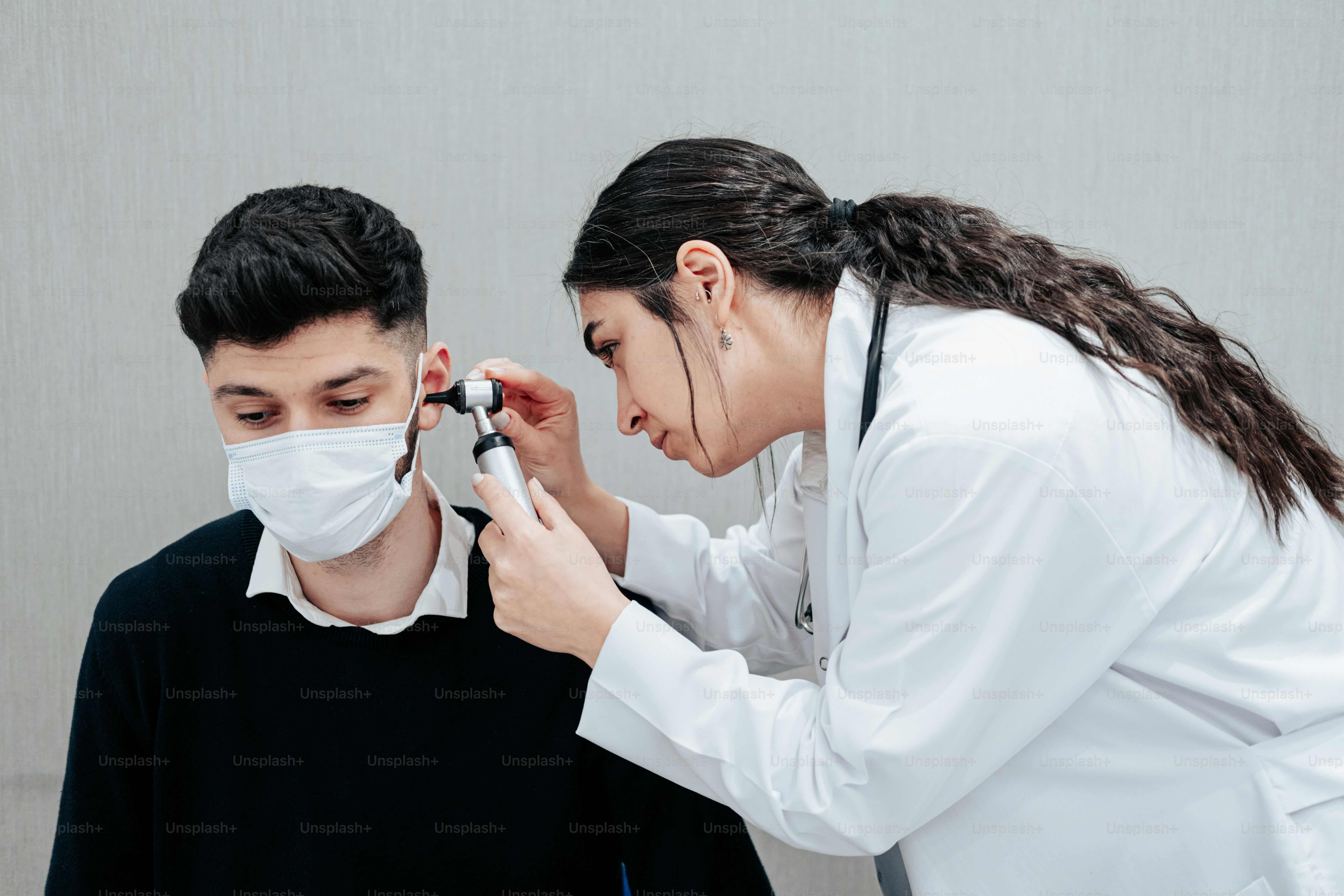 uma mulher usando uma máscara facial e um homem em uma camisa preta