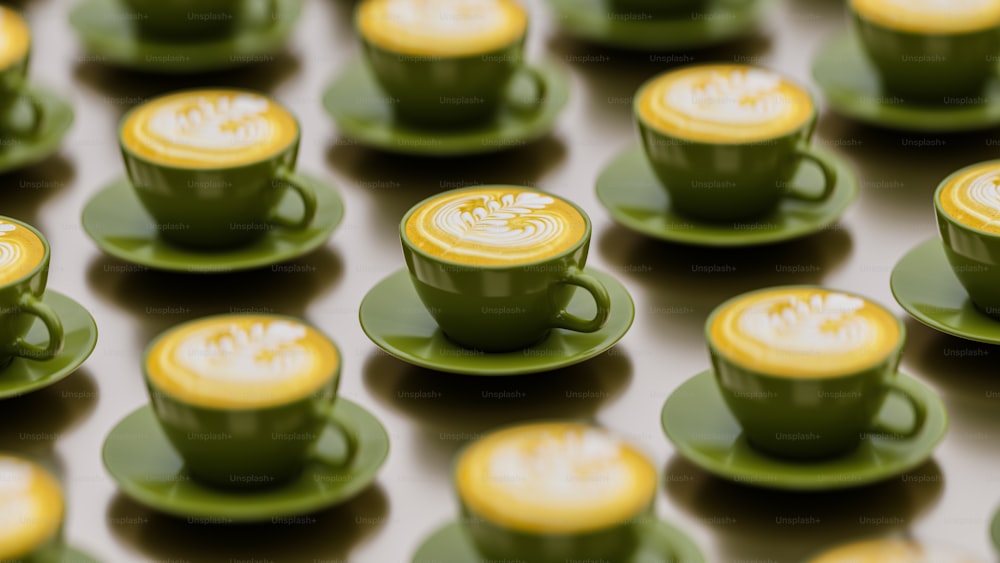 a group of green cups and saucers with yellow rims