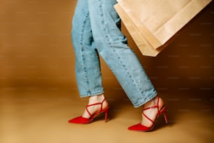 a woman in high heels holding a shopping bag