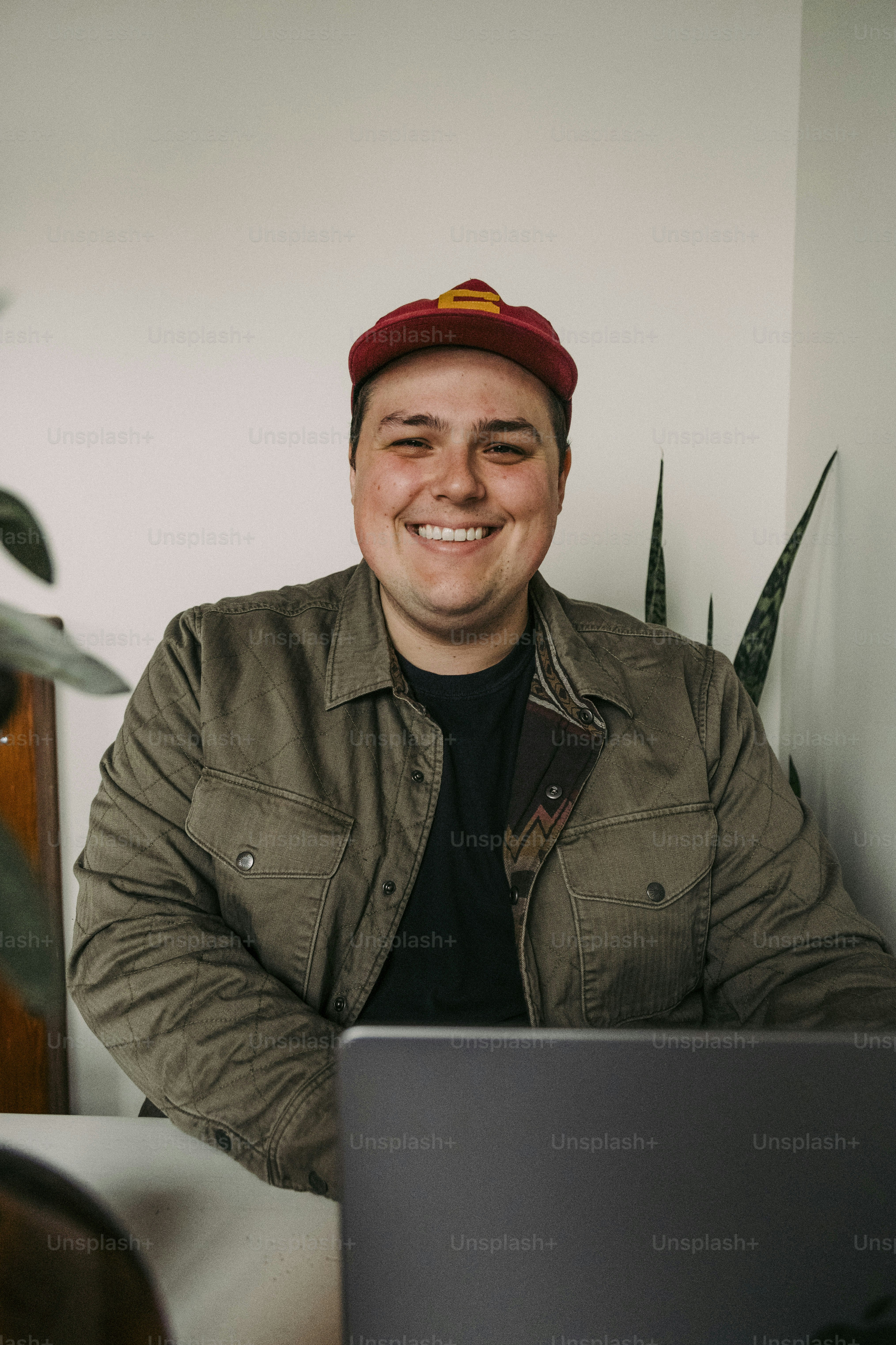 a man sitting in front of a laptop computer
