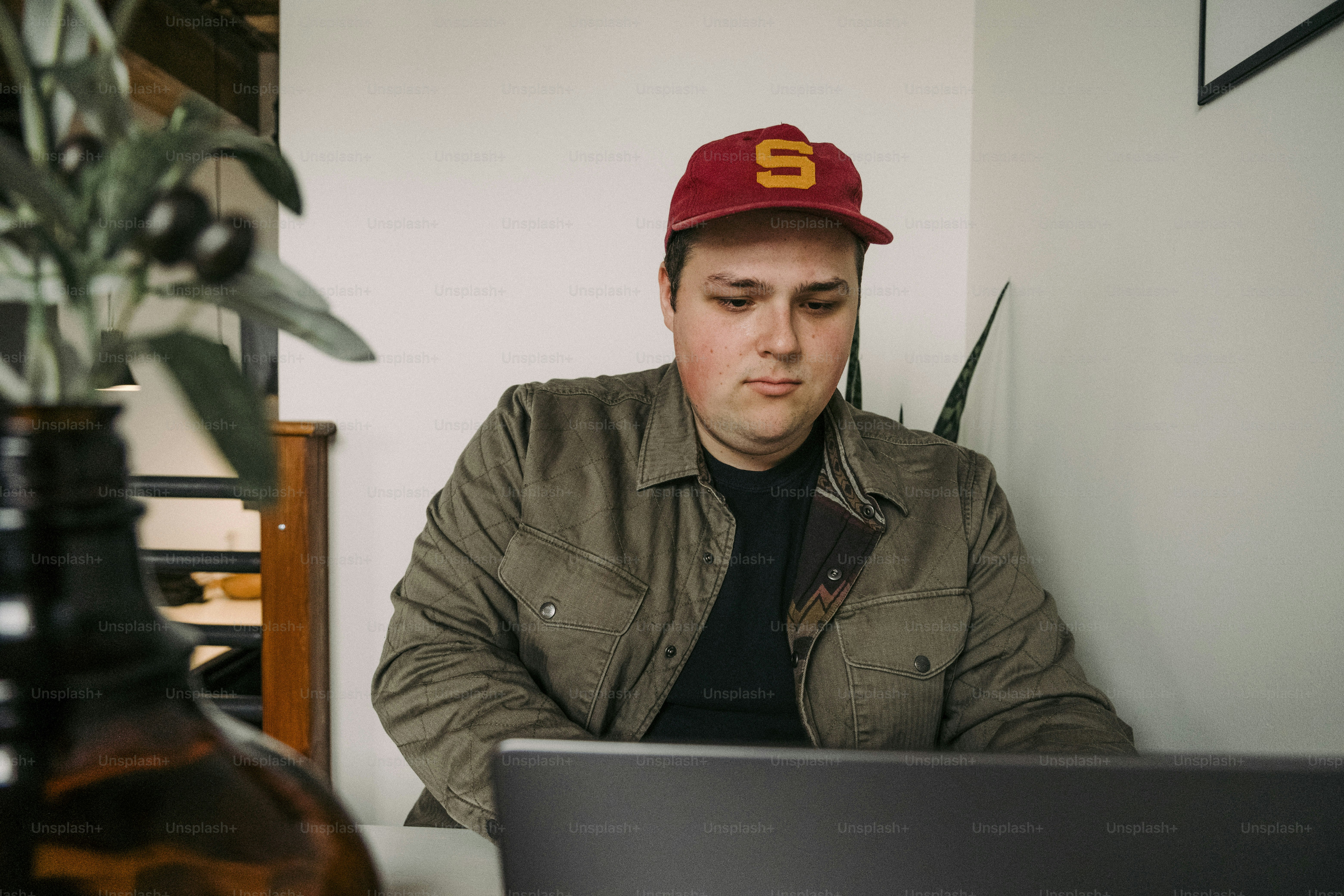 a man sitting at a desk with a laptop