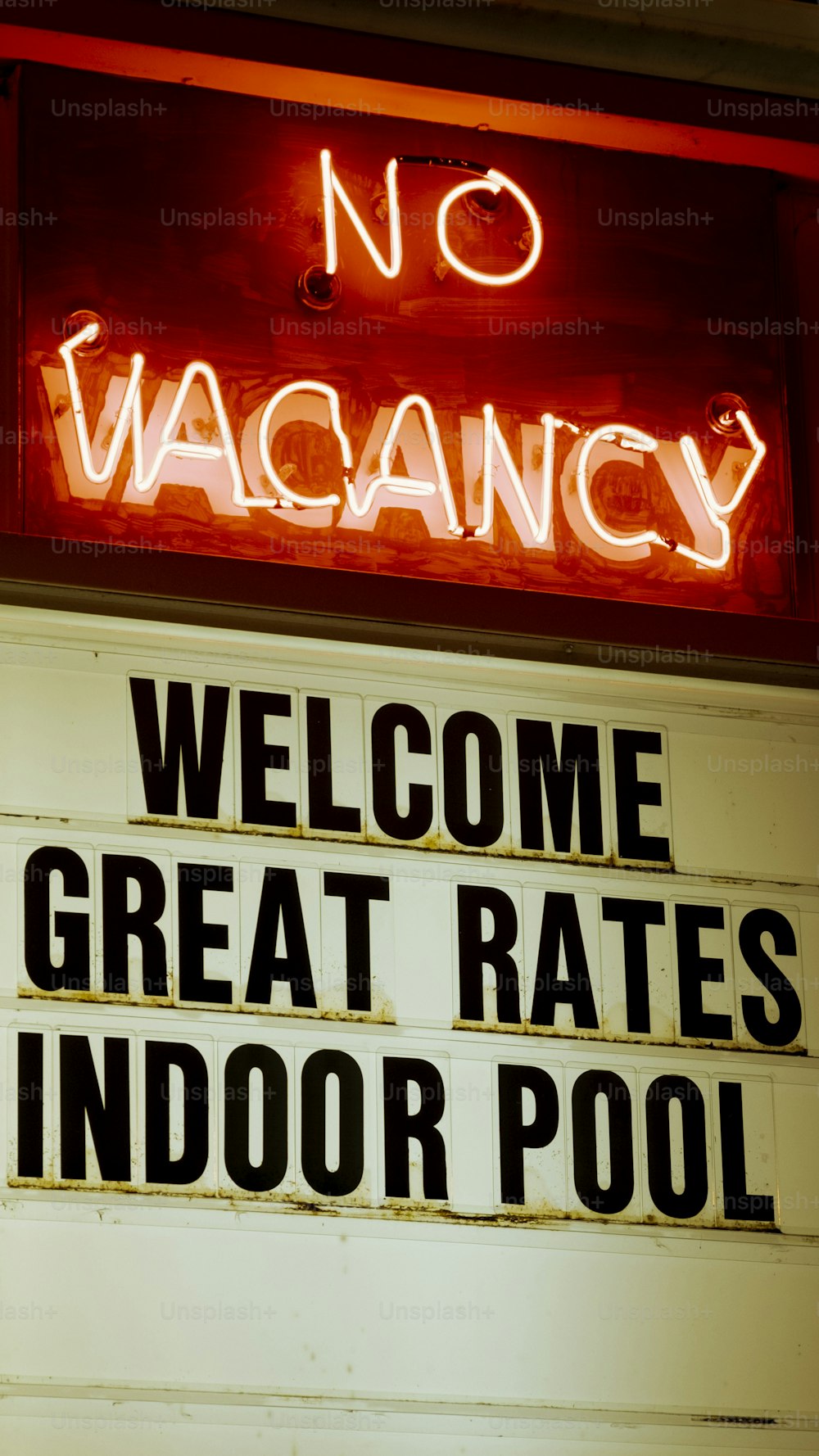 a neon sign that says no vacancy welcome great rate indoor pool