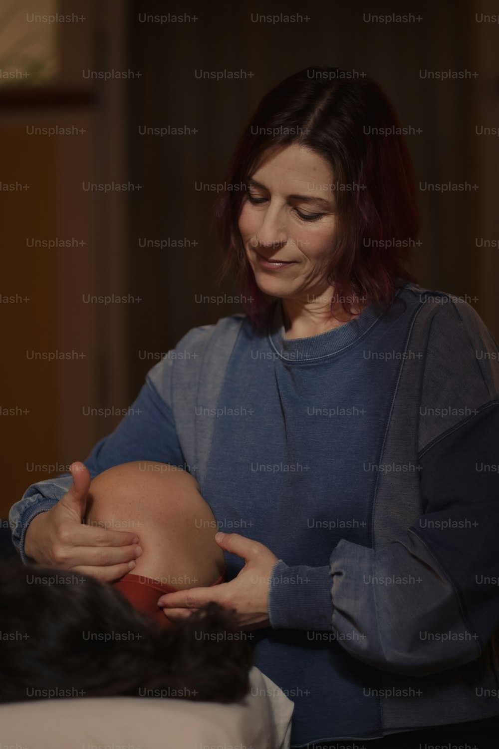 a woman is holding a pregnant woman's belly