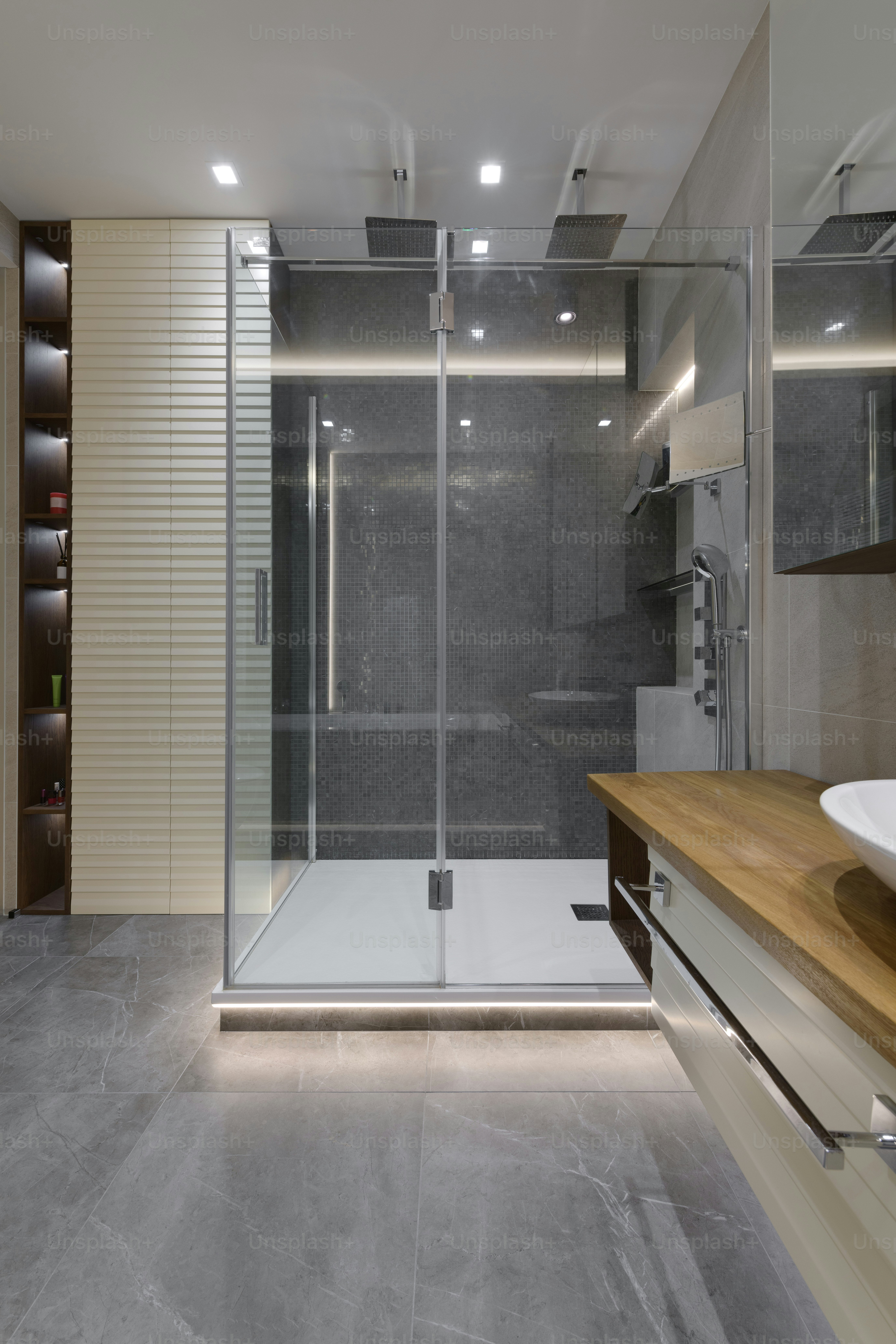 a bathroom with a walk in shower next to a sink
