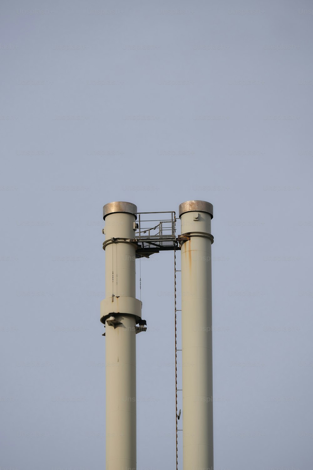 a couple of large metal pipes with a sky background