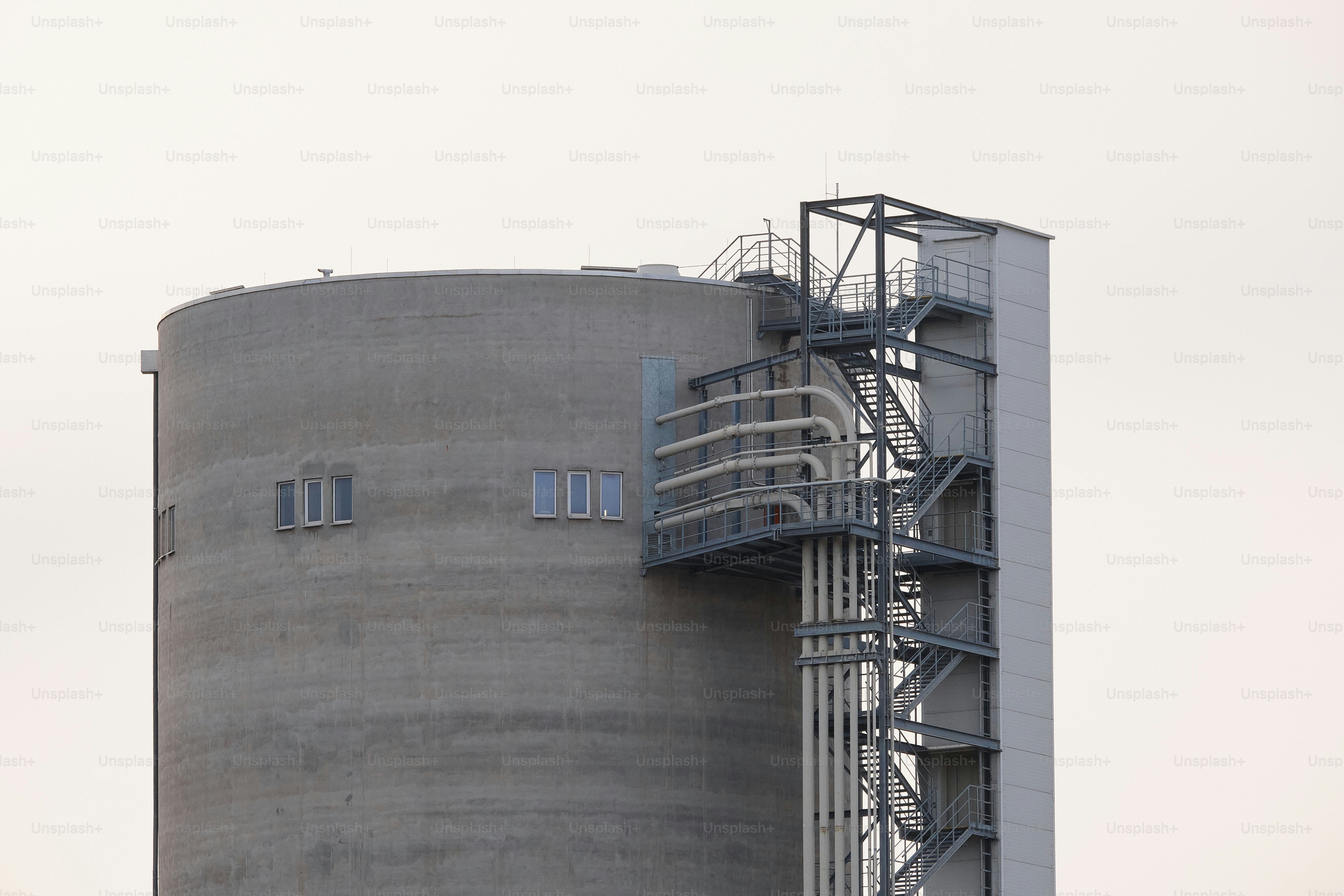 a large gray building with a clock on it's side