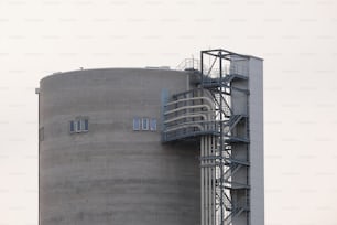 a large gray building with a clock on it's side