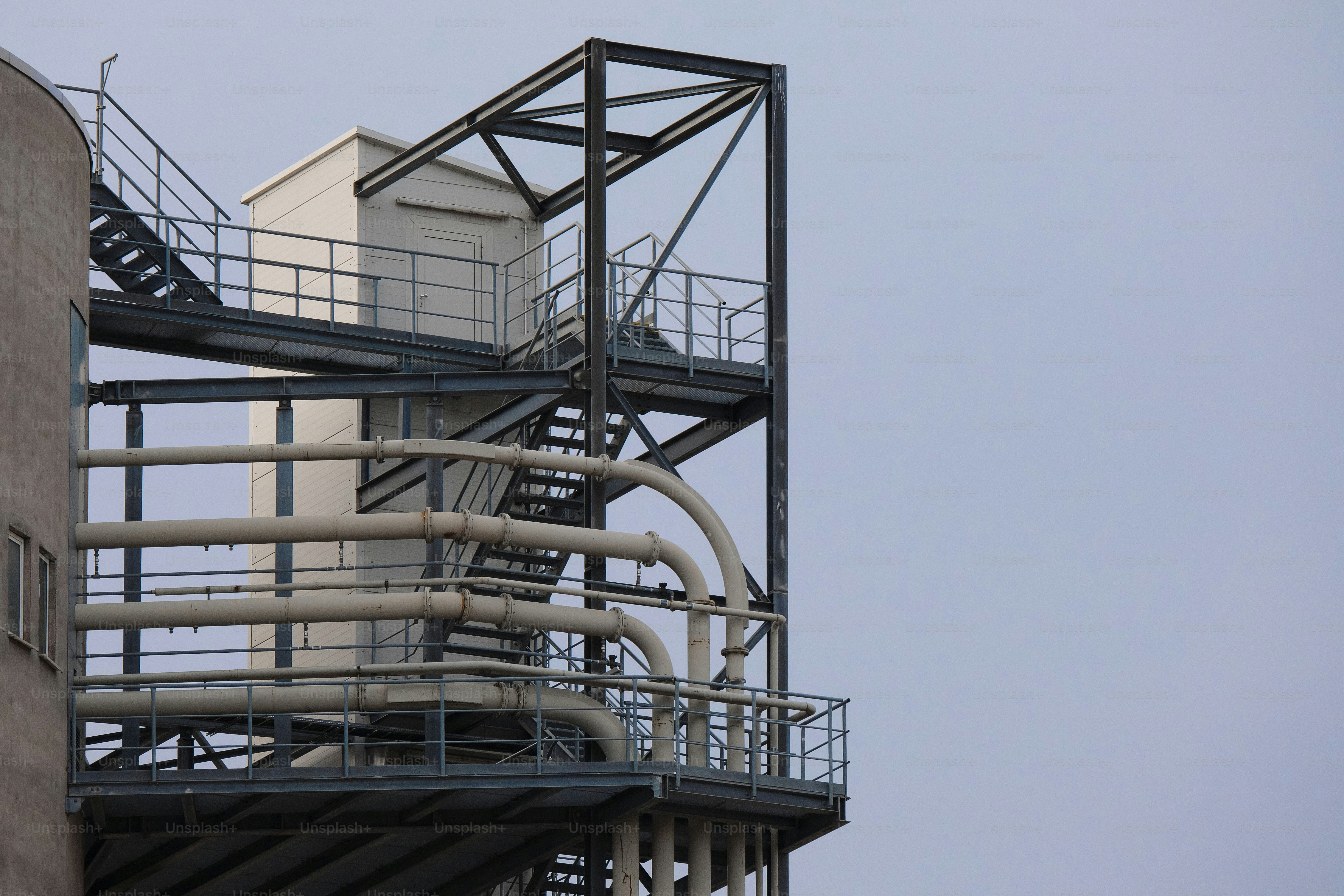 a large metal structure with a clock on top of it