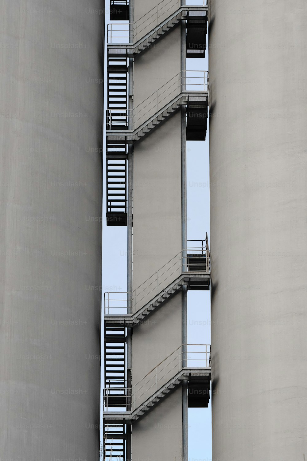 a tall building with a bunch of balconies next to it