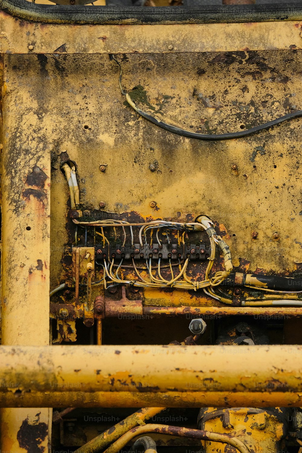 a close up of a rusted metal structure with wires