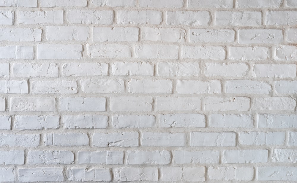 a close up of a white brick wall