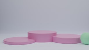 a group of three pink and green stools