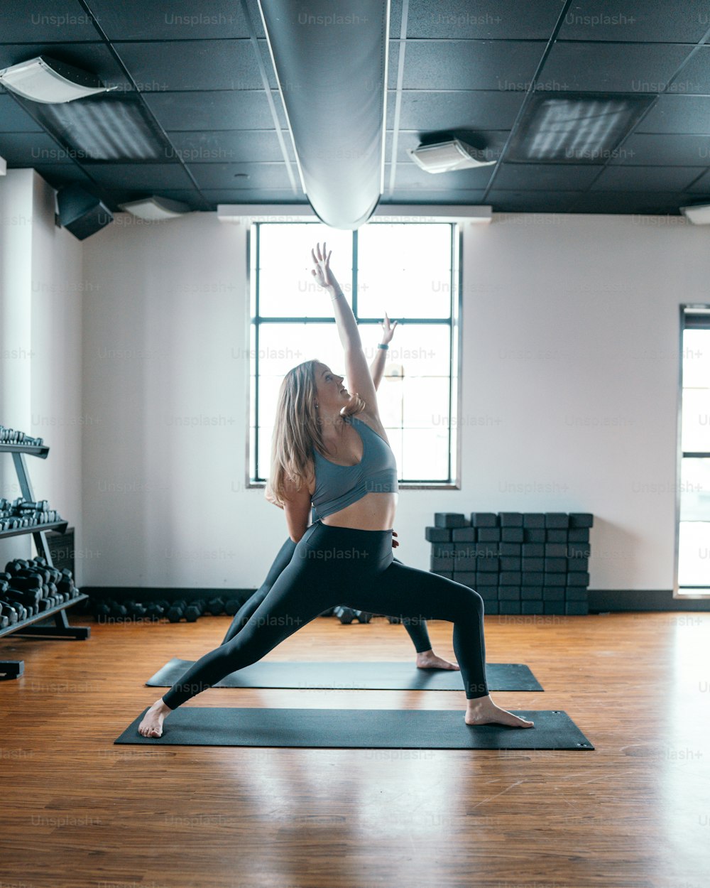 a woman is doing yoga in a gym