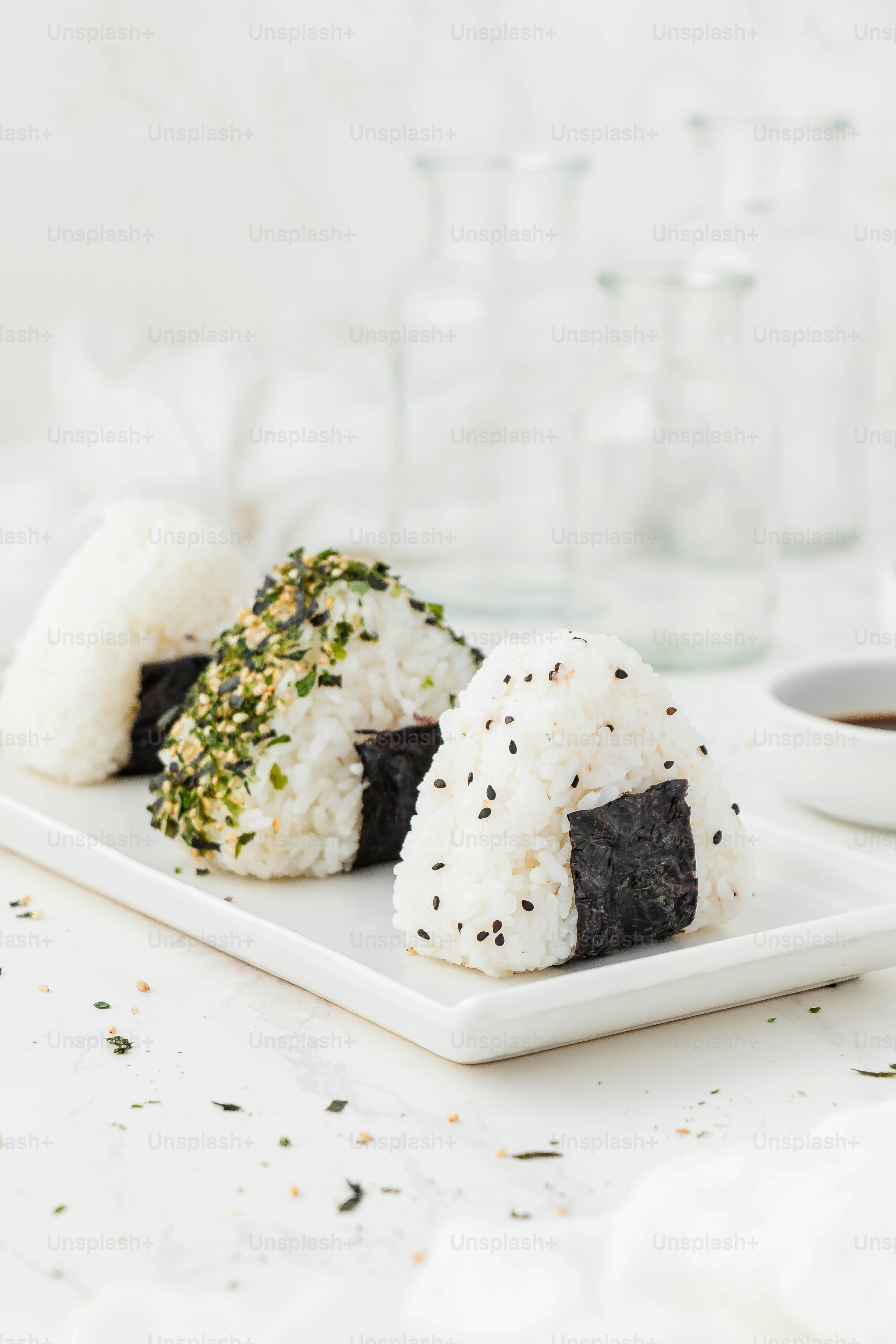 a white plate topped with sushi next to a cup of coffee