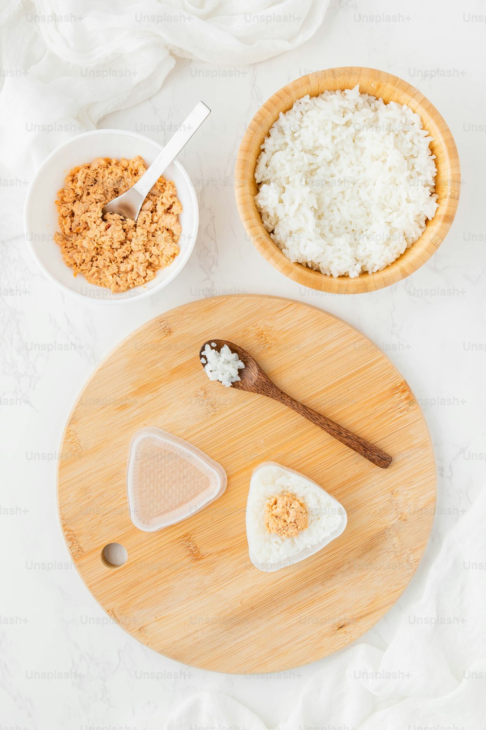 a wooden cutting board topped with cheese and other foods