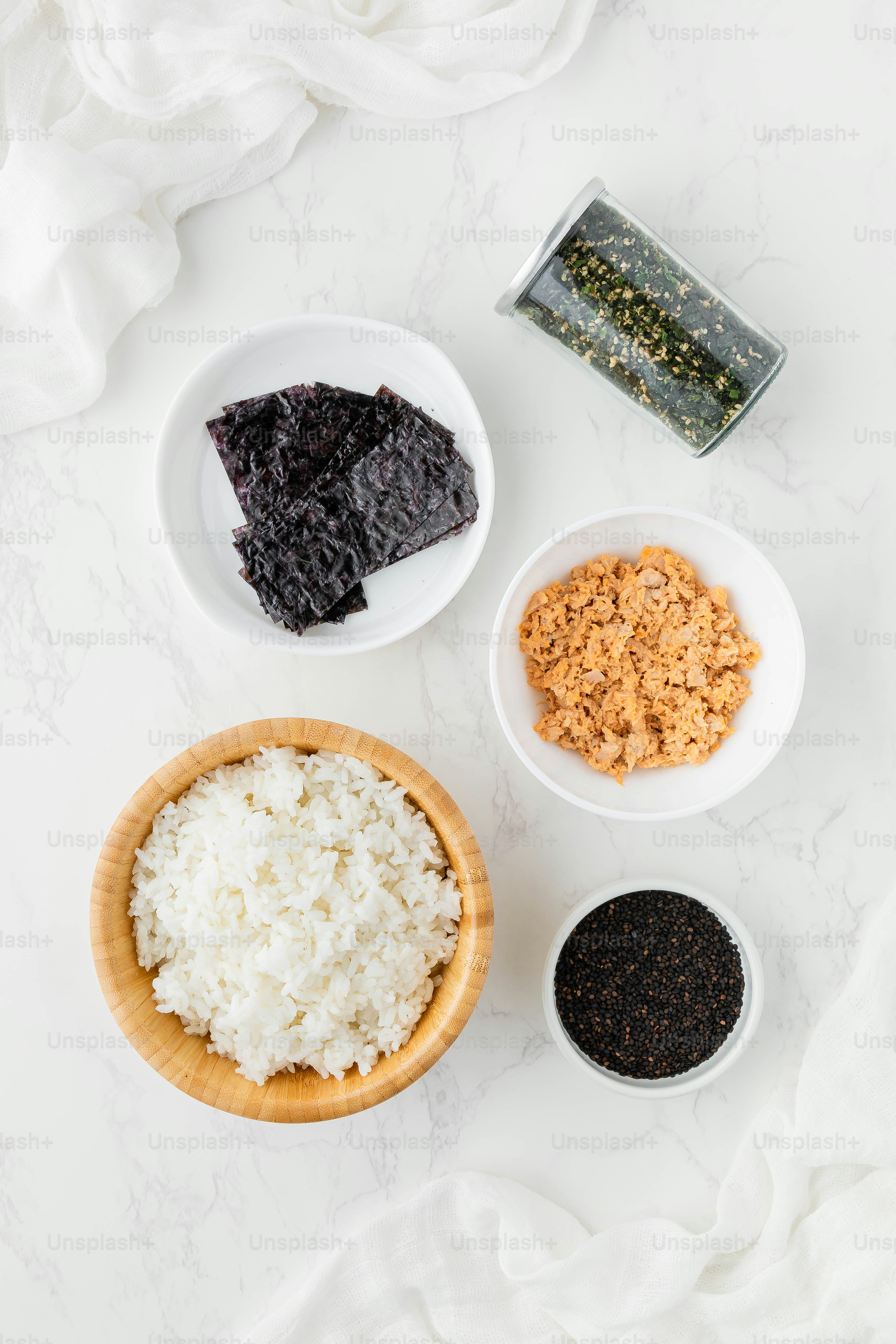 a white table topped with bowls filled with different types of food