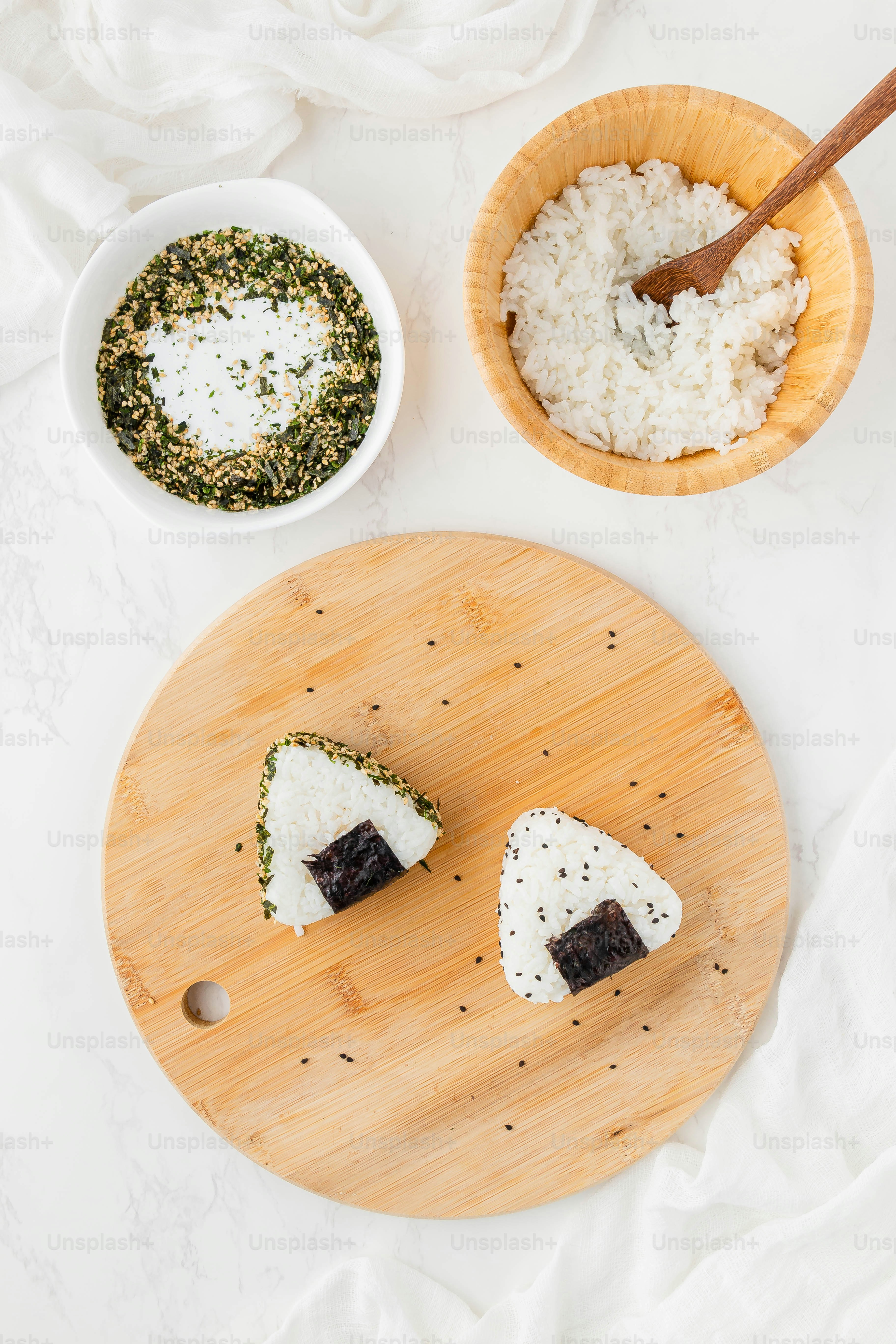 a wooden cutting board topped with pieces of sushi