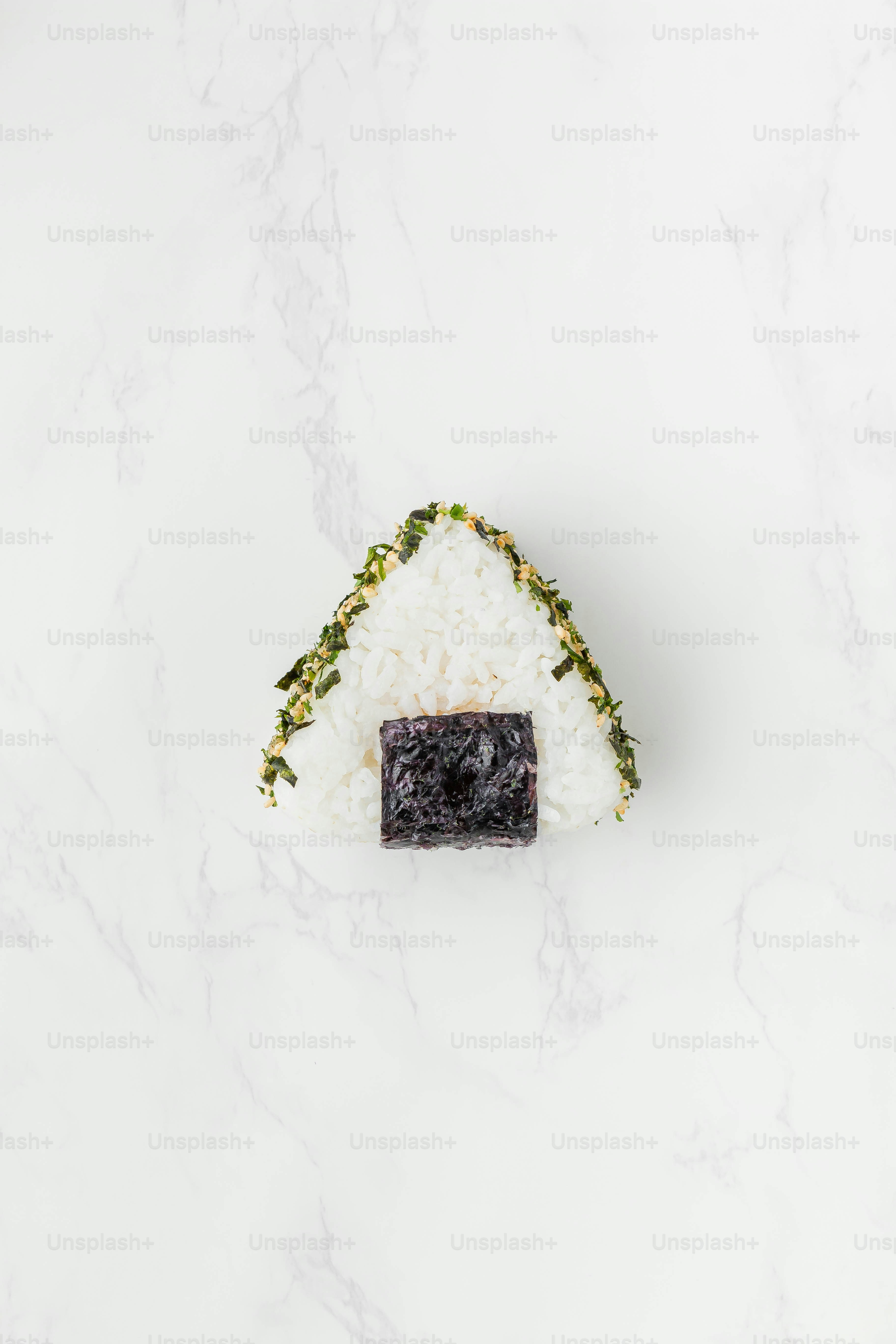 a piece of sushi sitting on top of rice