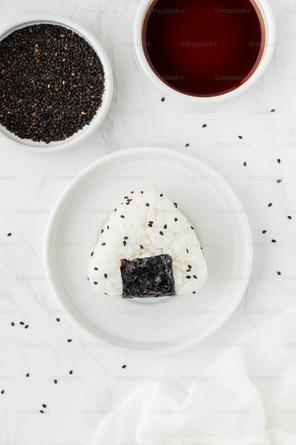 a white plate topped with a piece of cake next to a cup of tea