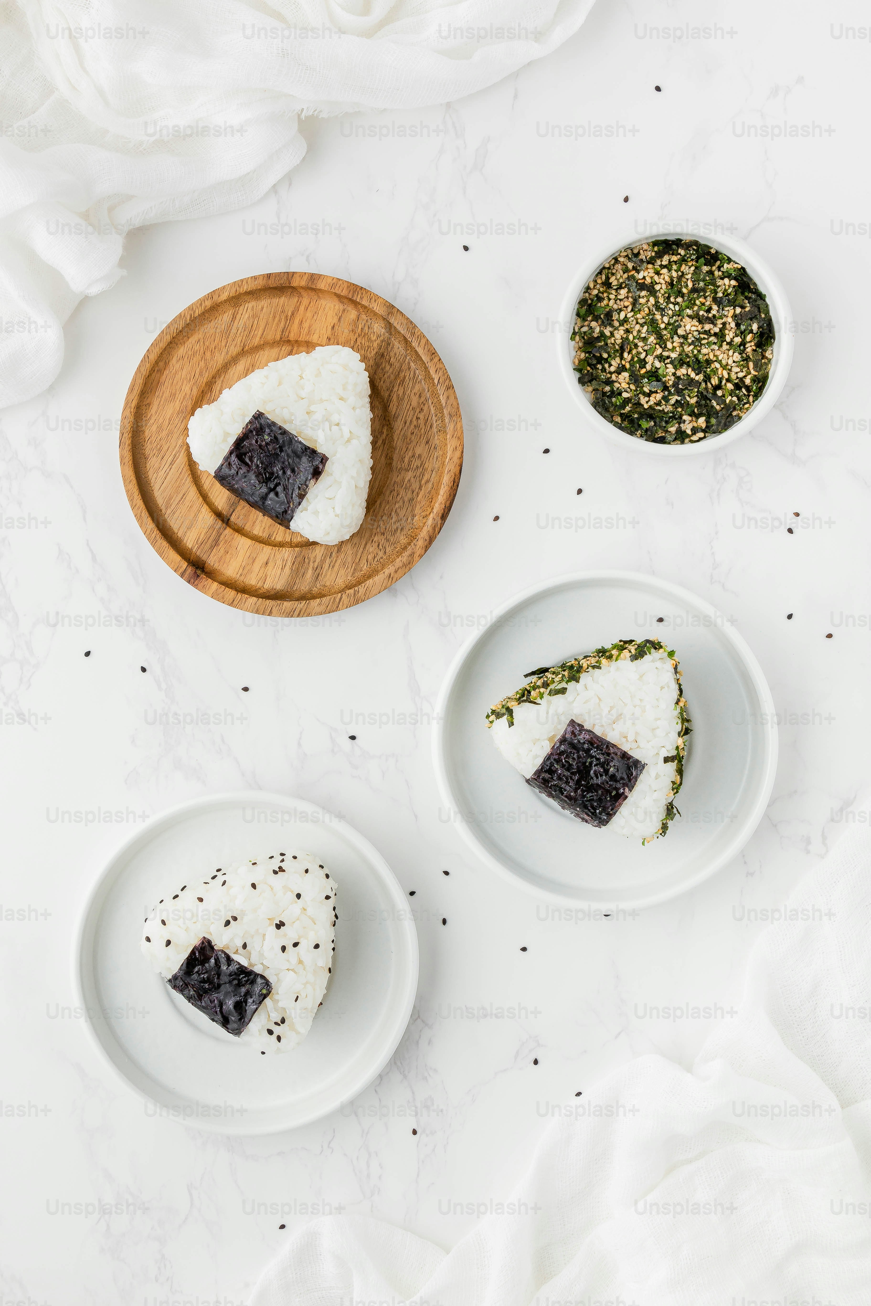 three plates of food on a white table