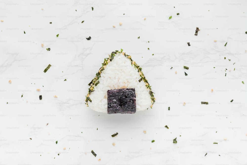 a piece of sushi sitting on top of rice