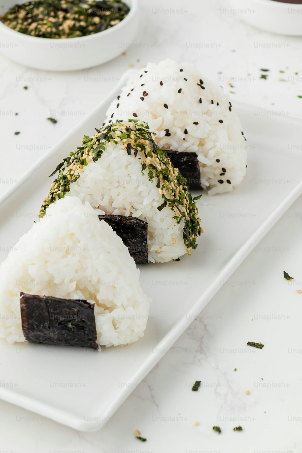 a white plate topped with sushi and rice