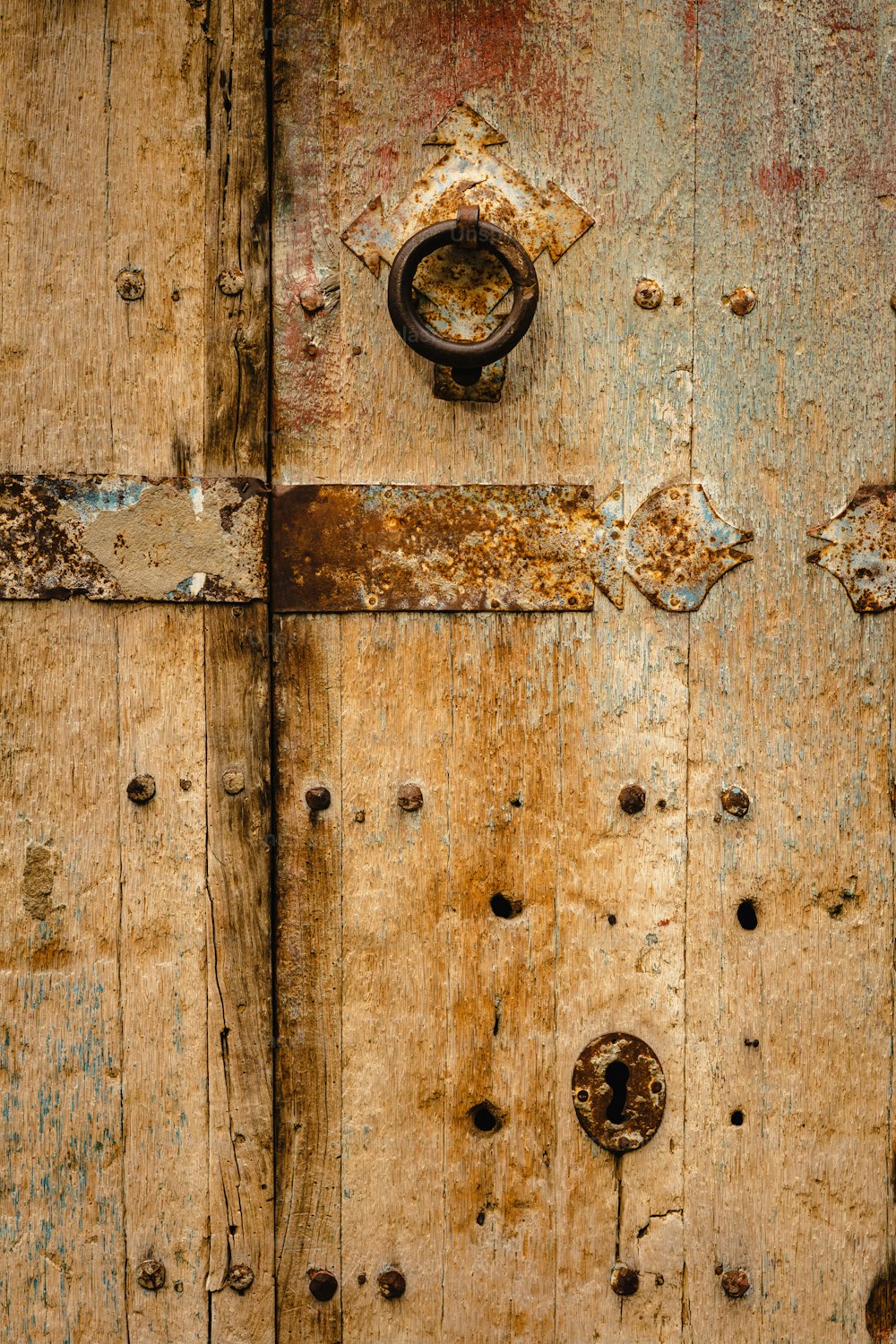 a close up of a wooden door with rust