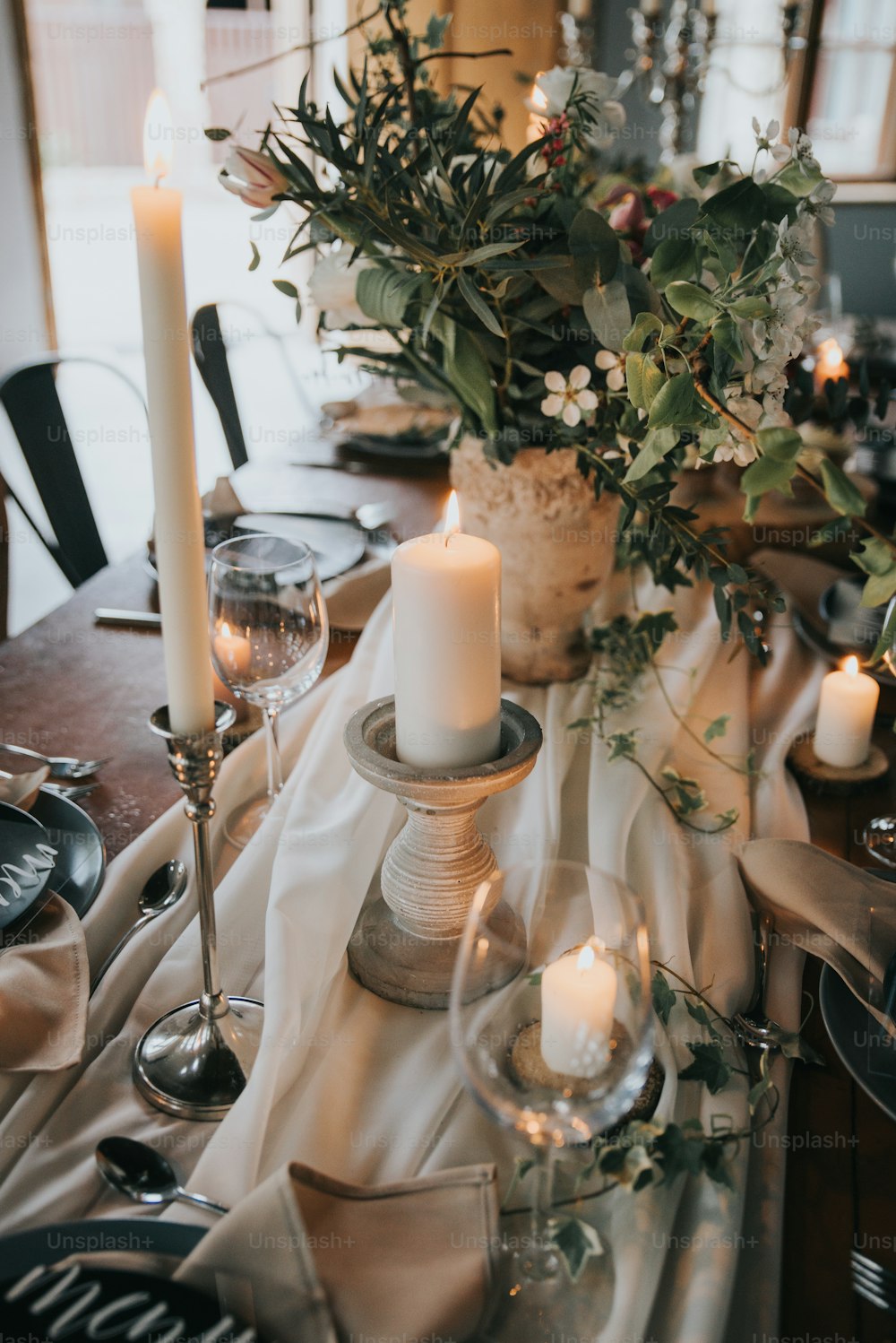 ein Tisch mit Kerzen und Blumen darauf