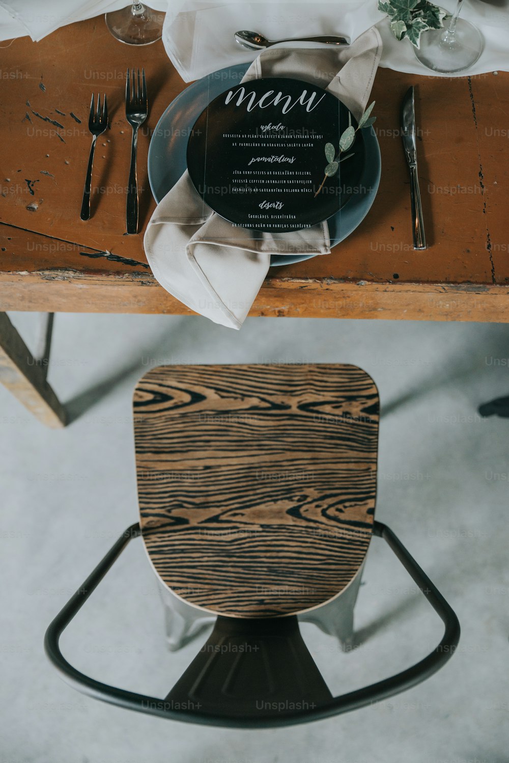 une table en bois surmontée d’une assiette noire