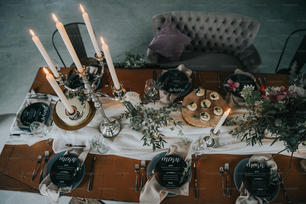 a table topped with lots of food and candles