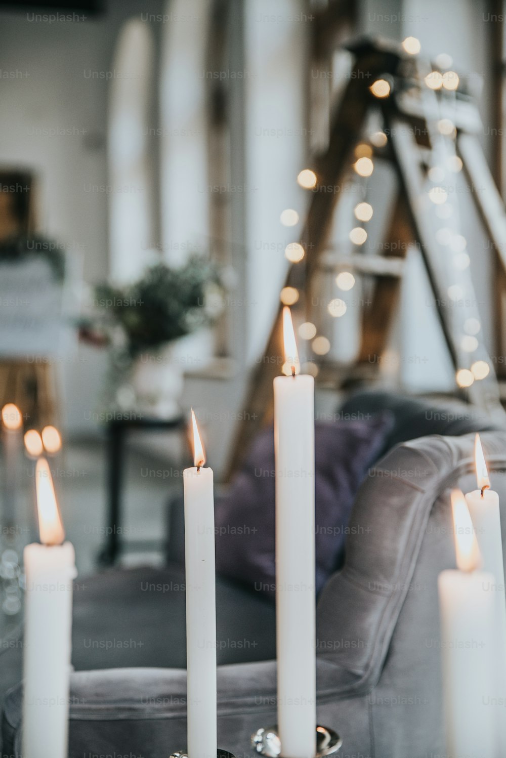 a group of white candles sitting on top of a table