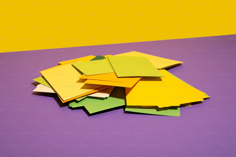 a pile of yellow and green post it notes