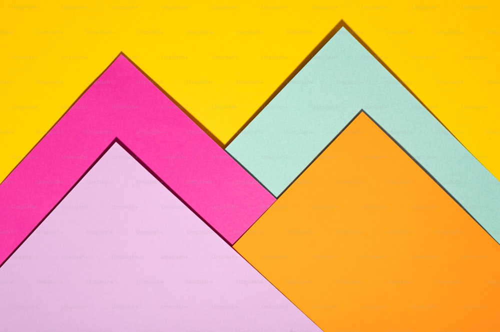a group of different colored papers on a yellow background