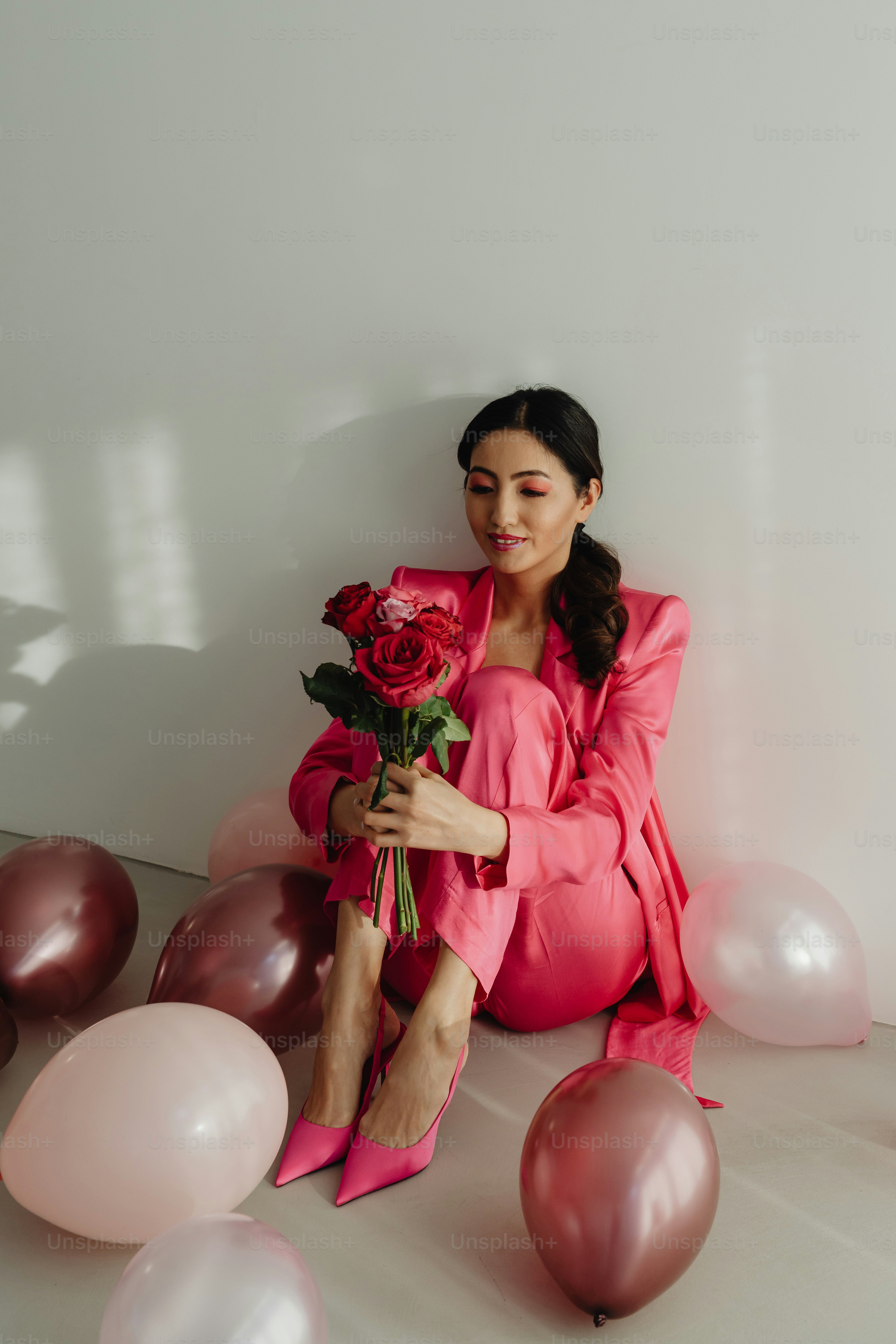 A woman in a pink dress holding a rose photo – Asian Image on Unsplash
