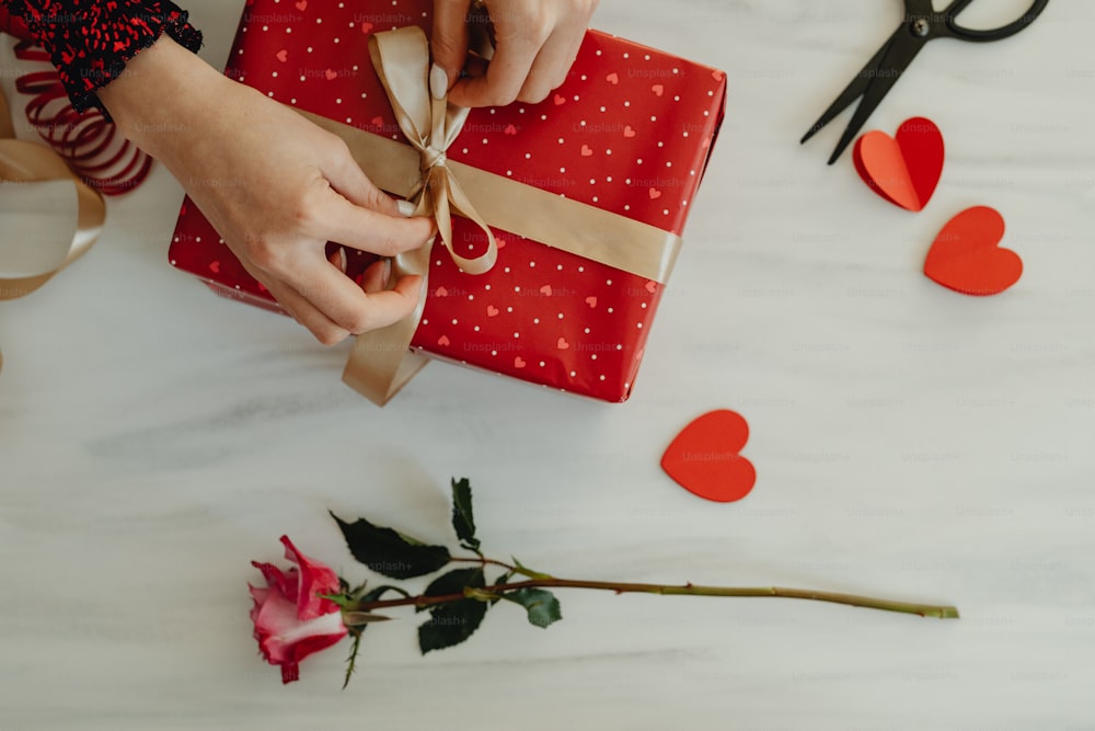 a person wrapping a present on a table