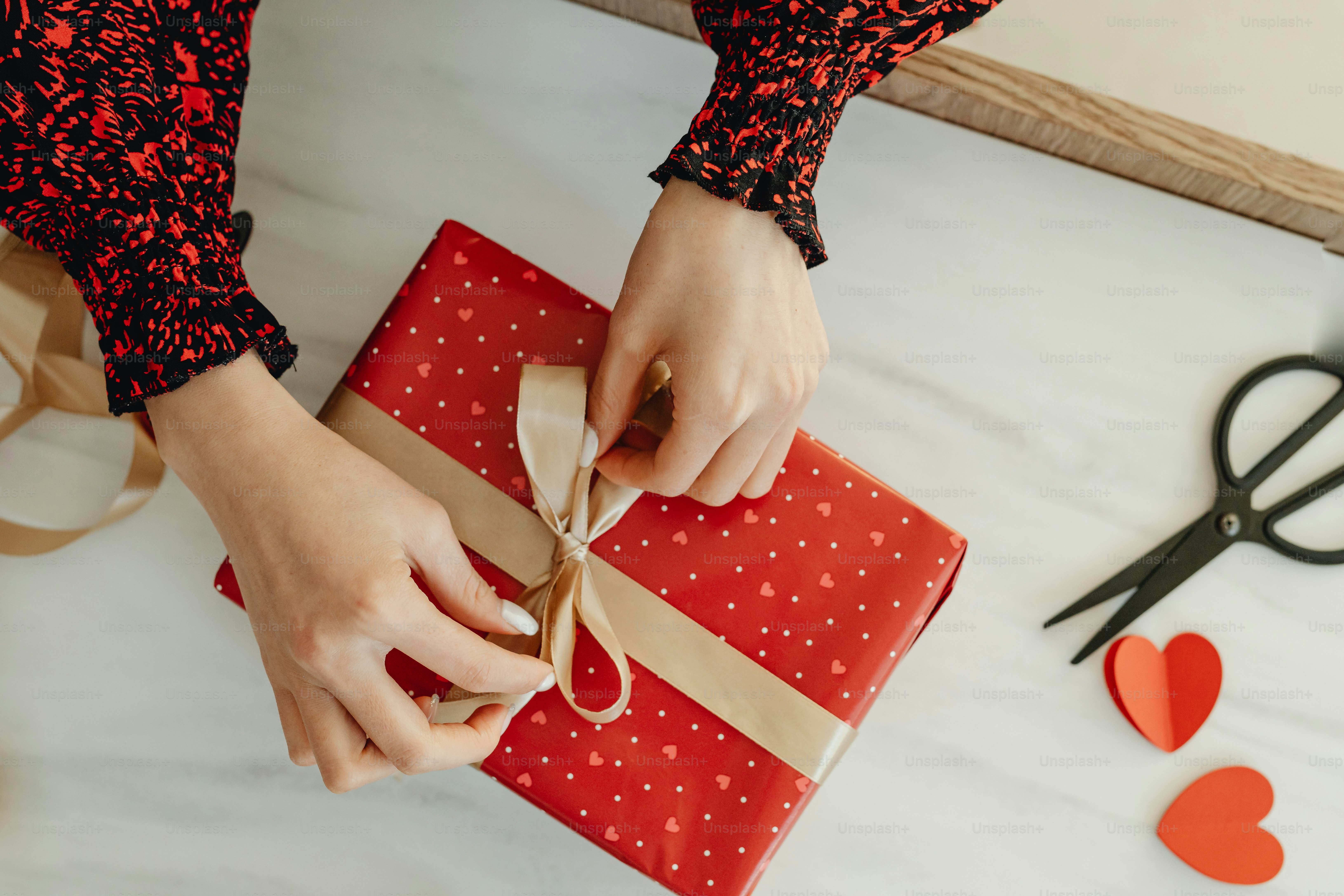 a person wrapping a present on a table