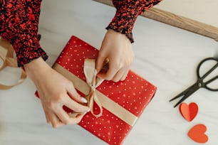 a person wrapping a present on a table