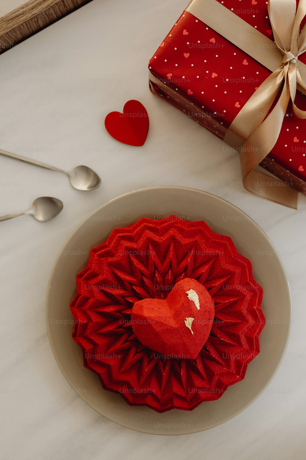 a heart shaped cake sitting on top of a white plate