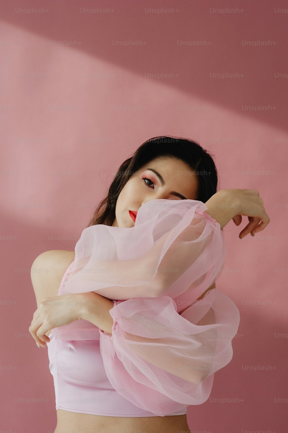 a woman in a pink top posing for a picture