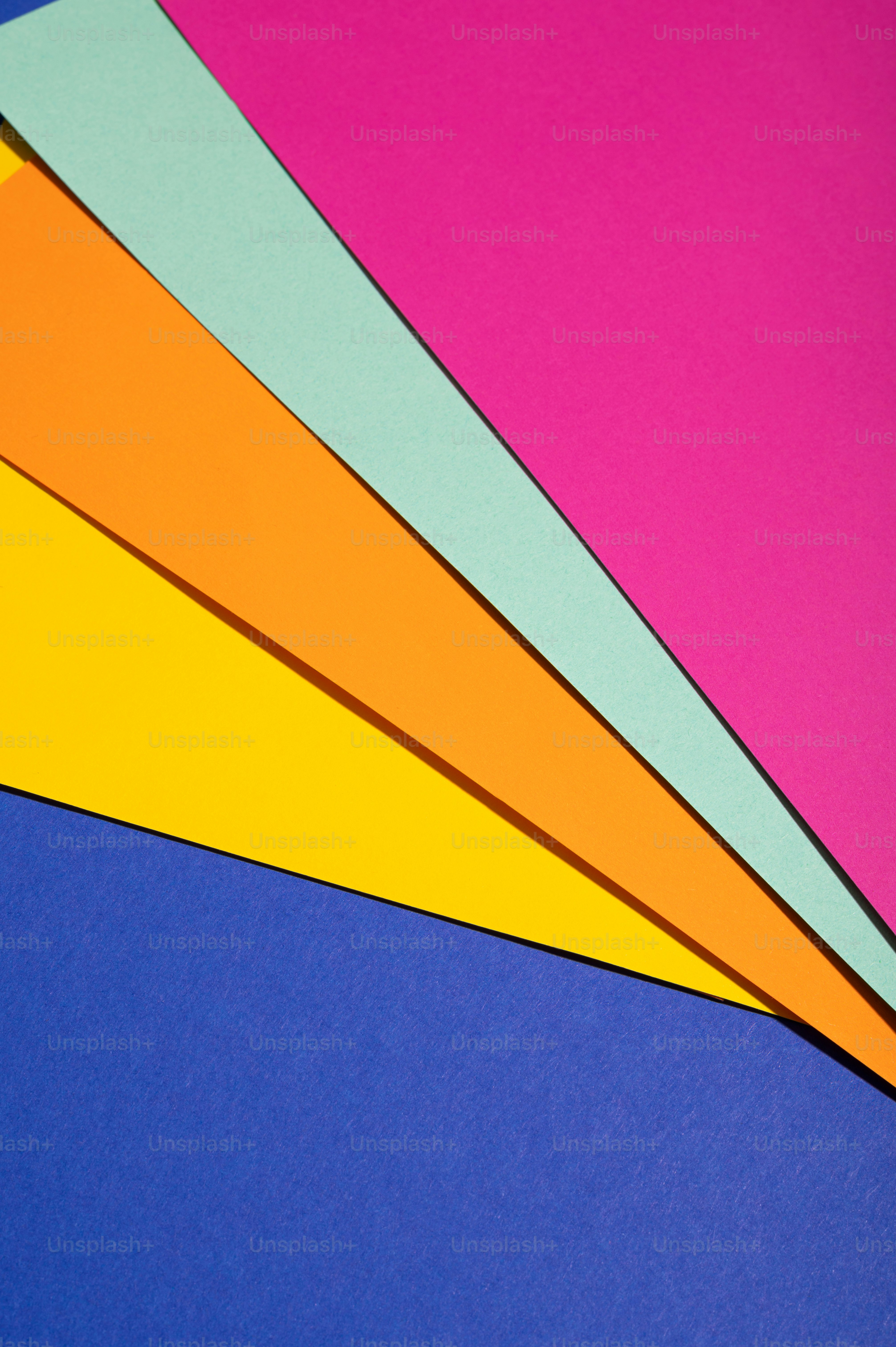 A bunch of different colored papers laying on top of each other photo