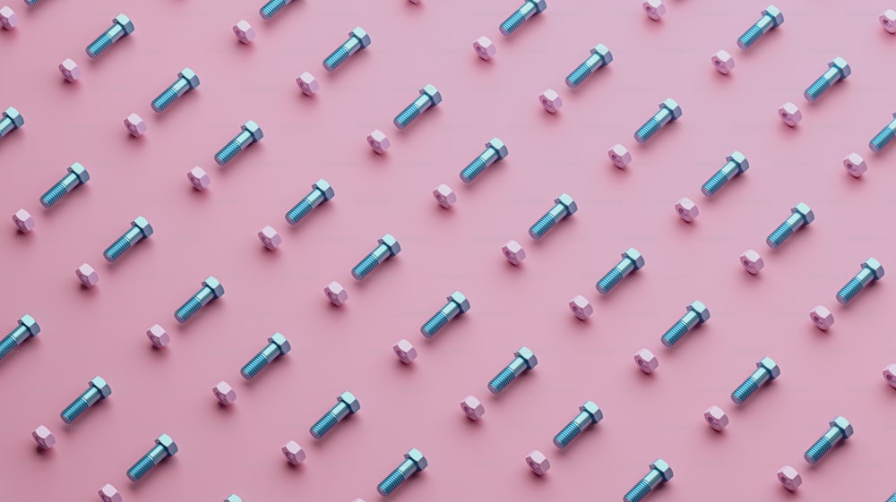 a pink background with a bunch of silver screws
